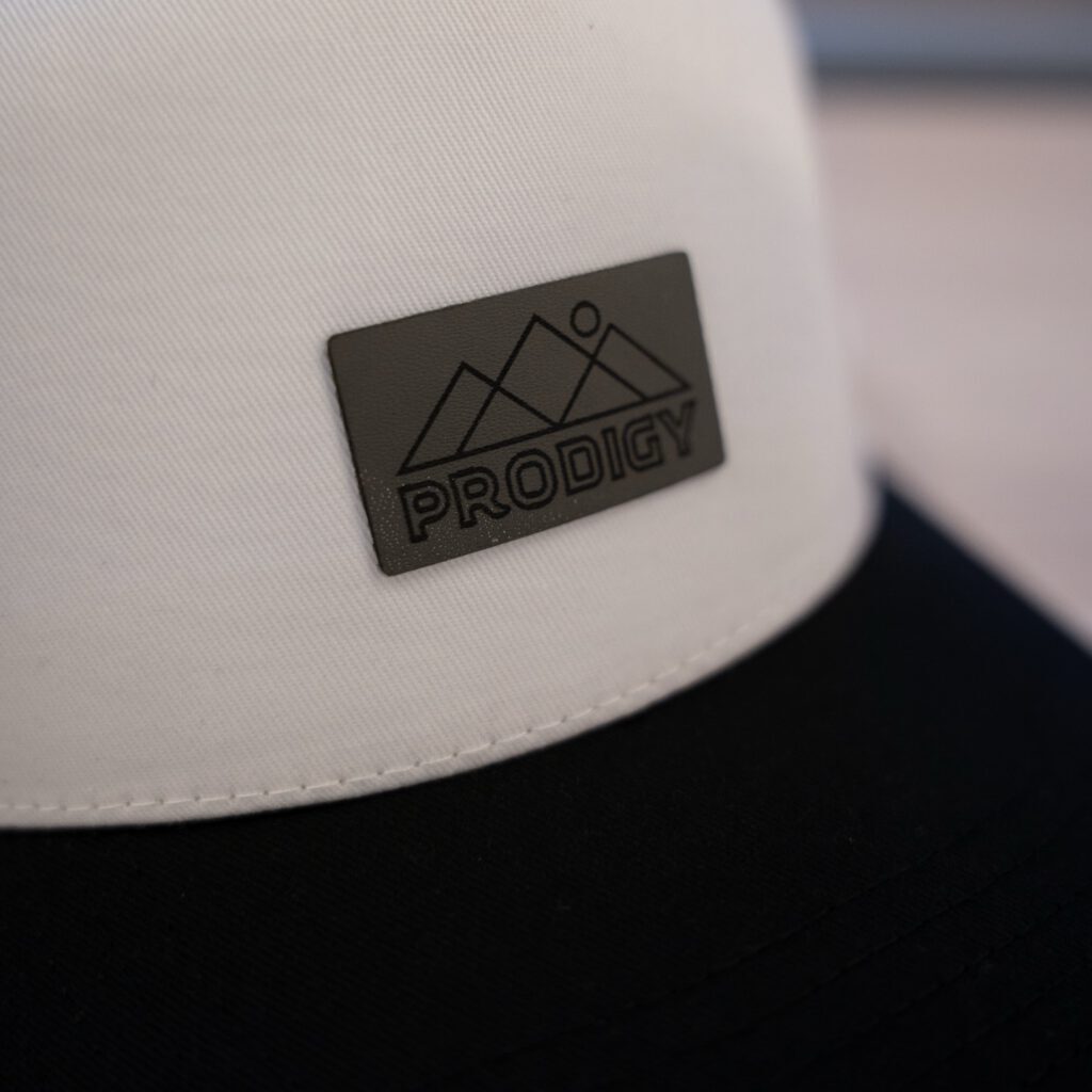 Close-up of the stitching on a leather mountain-design cap patch