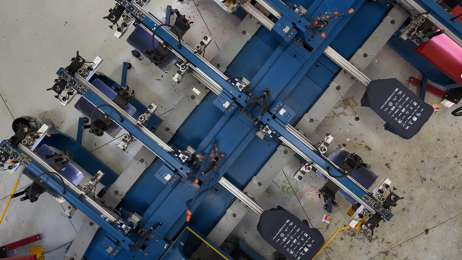 Overhead view of Prodigy Promos' automatic screen-printing carousel running a job on the production floor in Lindon, Utah