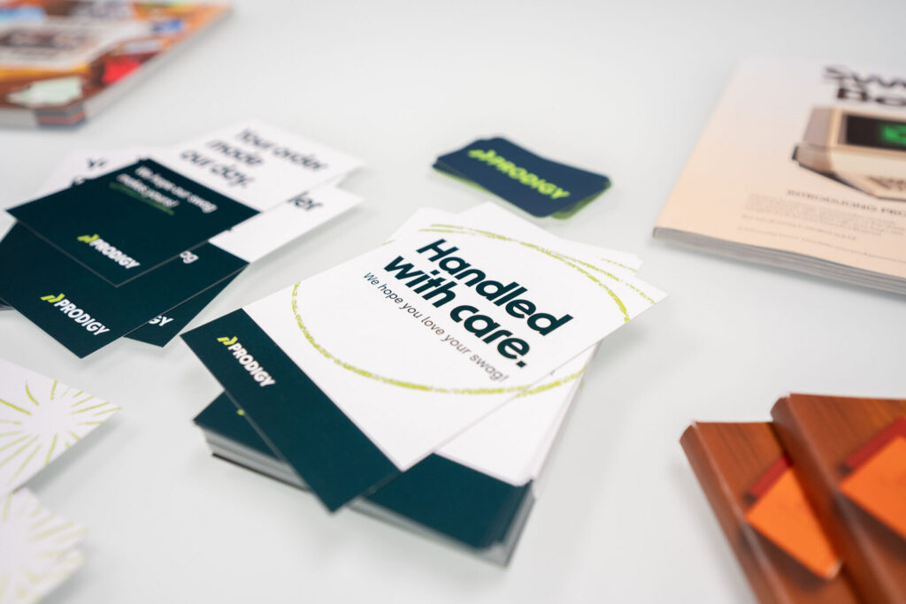 Printed insert cards and branded collateral laid out on a white surface