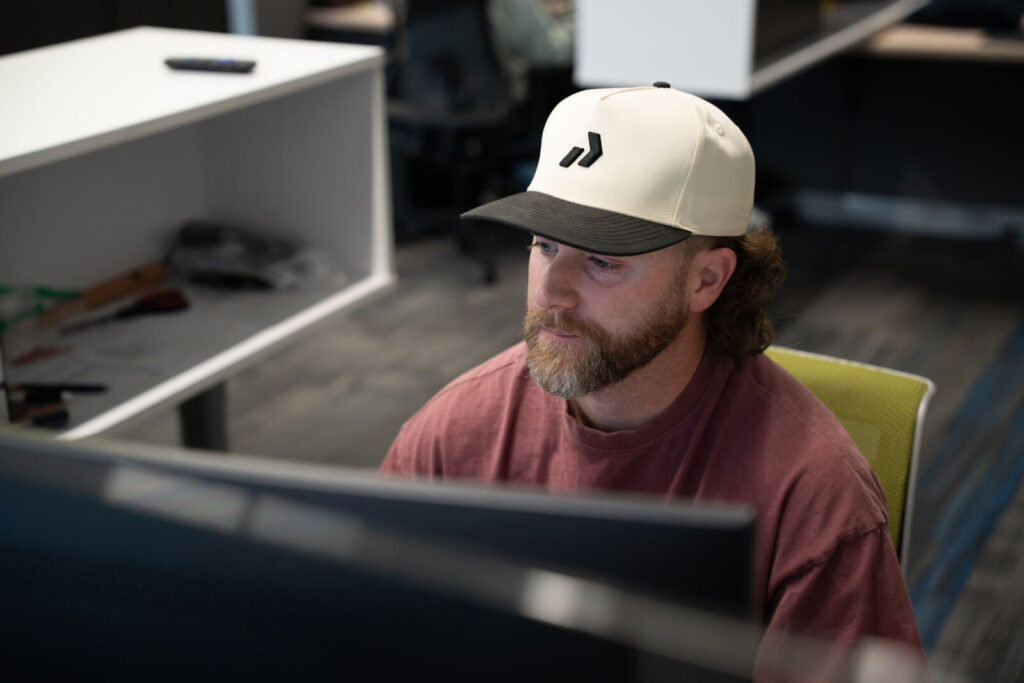 Tanner Johnson, an account manager at Prodigy Promos, working at his desk in Lindon, Utah